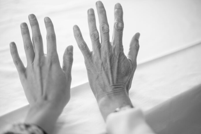 Photo by Malin K. persons left hand on white textile